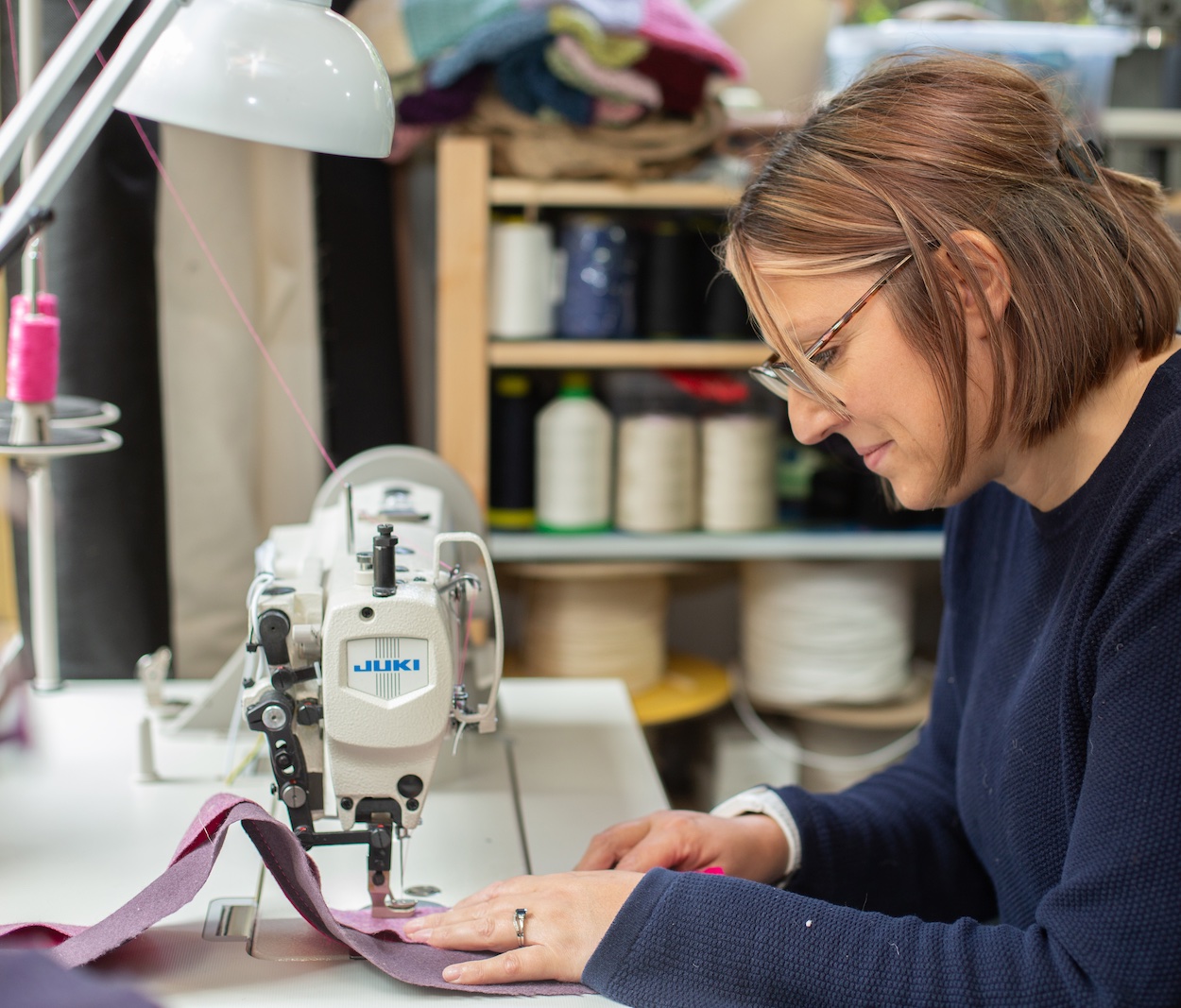 Kate operating sewing machine