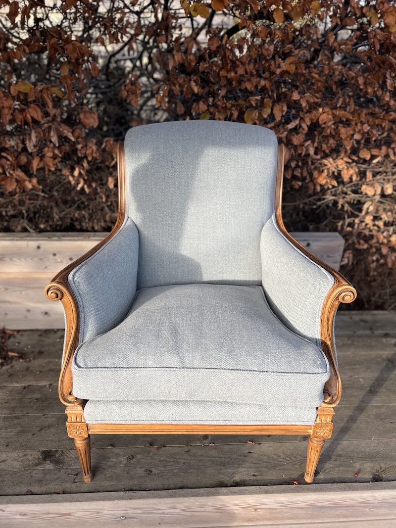 Elegant French style armchair featuring a refined wooden frame and soft blue upholstery, adding sophistication to any space.