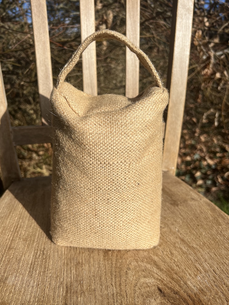 Natural hessian door weight with a convenient handle, perfect for keeping doors securely closed.