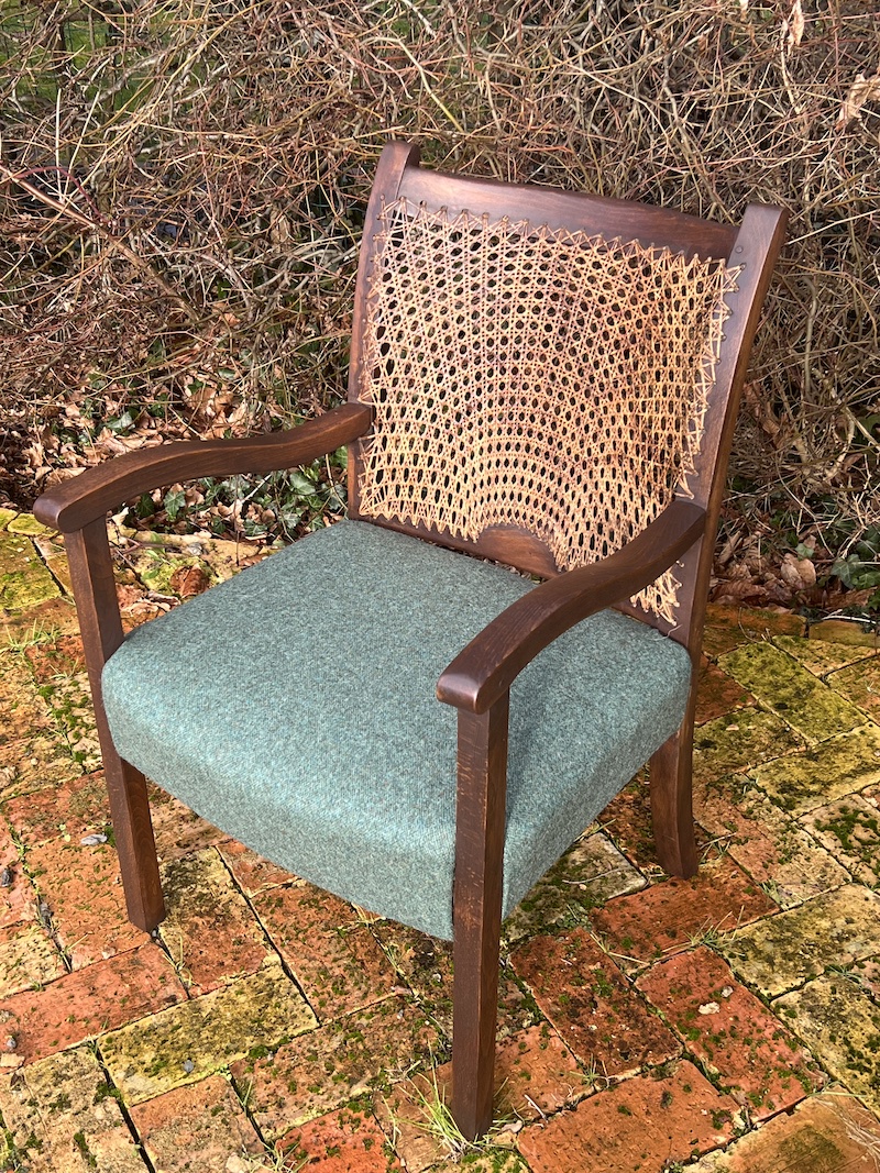 Stylishly designed, the Rising Sun Cane Chair features a woven backrest and plush seating, perfect for any modern space.
